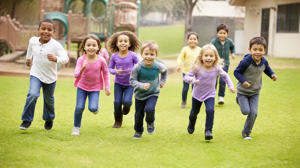 Children and caregivers enjoying an outdoor group activity